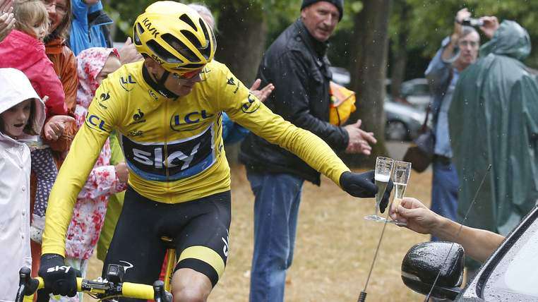 Christopher Froome 2015 Tour de France winner drinks a glass of champagne during the final 21st stage: Team Sky principal Sir David Brailsford, who was driving beside him, handed Chris Froome a glass of champagne to drink as he rode out the closing stages