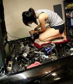 Woman Working On Car
